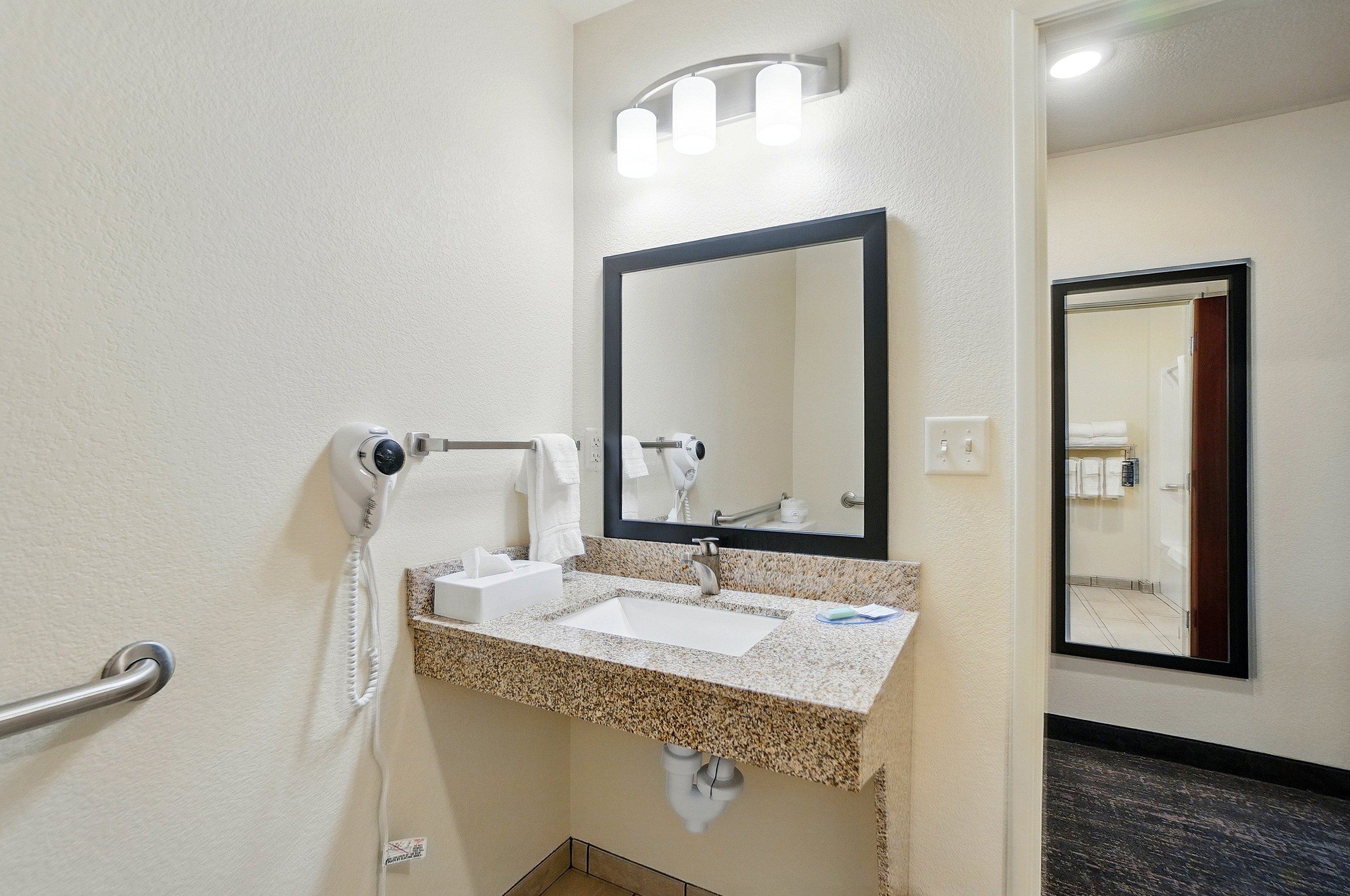 COBBLESTONE HOTEL AND SUITES-guestroom-Accessible Bathroom With A Benched Tub.jpg