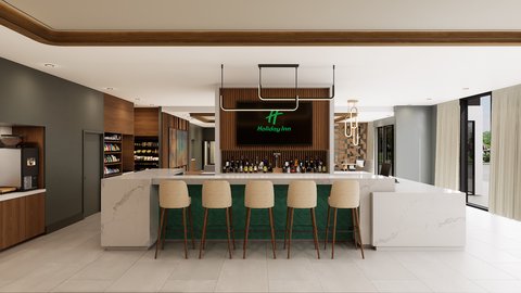 Hotel bar with stools, marble counter, and backlit sign.