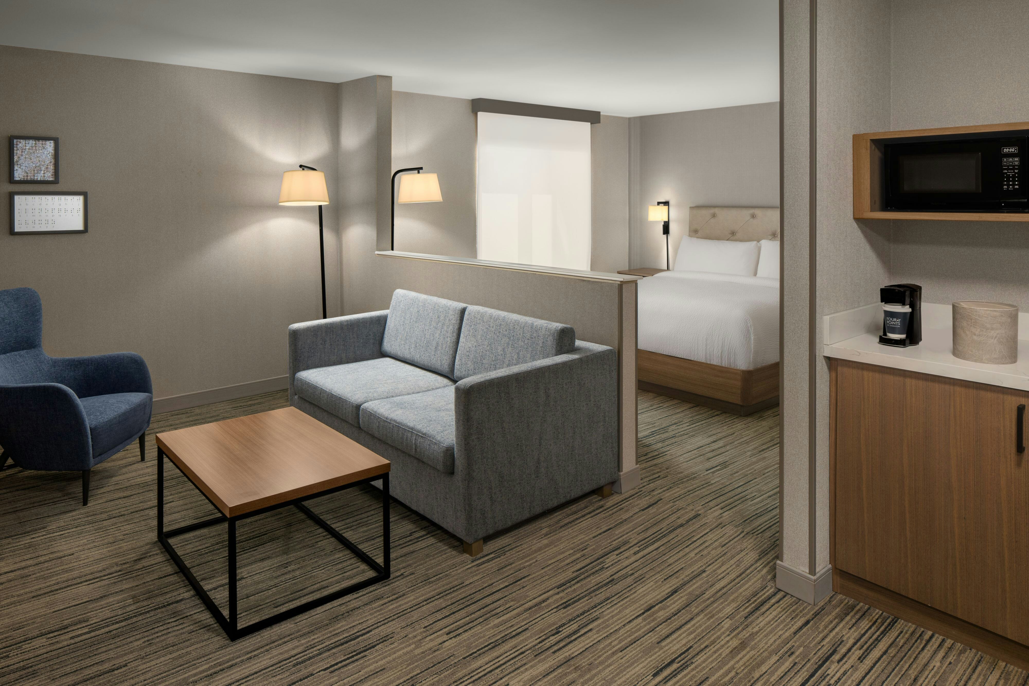 Four Points by Sheraton Downtown Seattle Center-guestroom-King Studio Suite - Living Room with bed.jpg