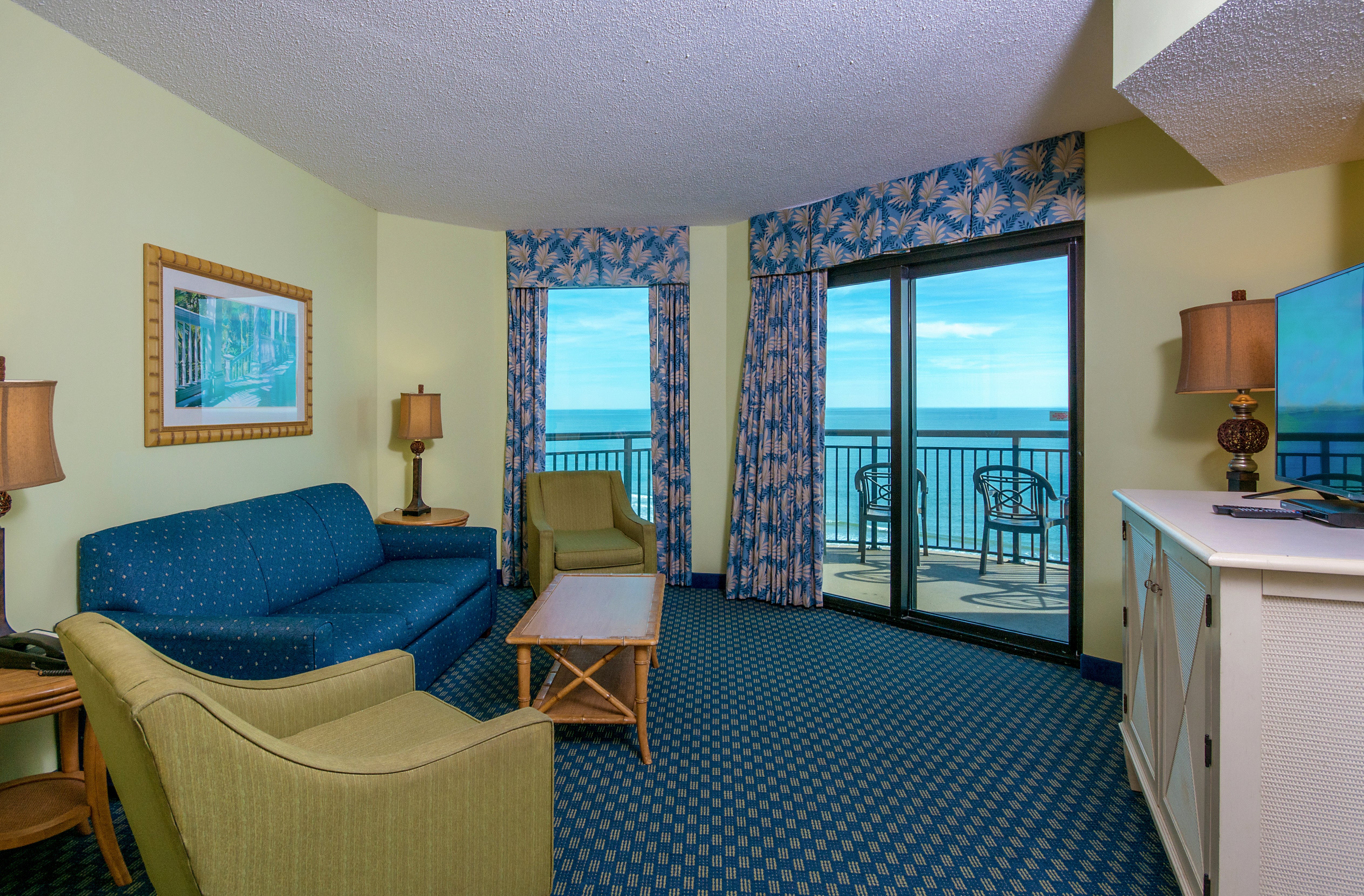 The Caribbean Resort and Villa-guestroom-caribbean cayman br oceanfront condo living room.jpg