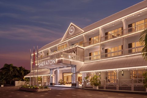 Grand resort frontage with tropical surroundings.