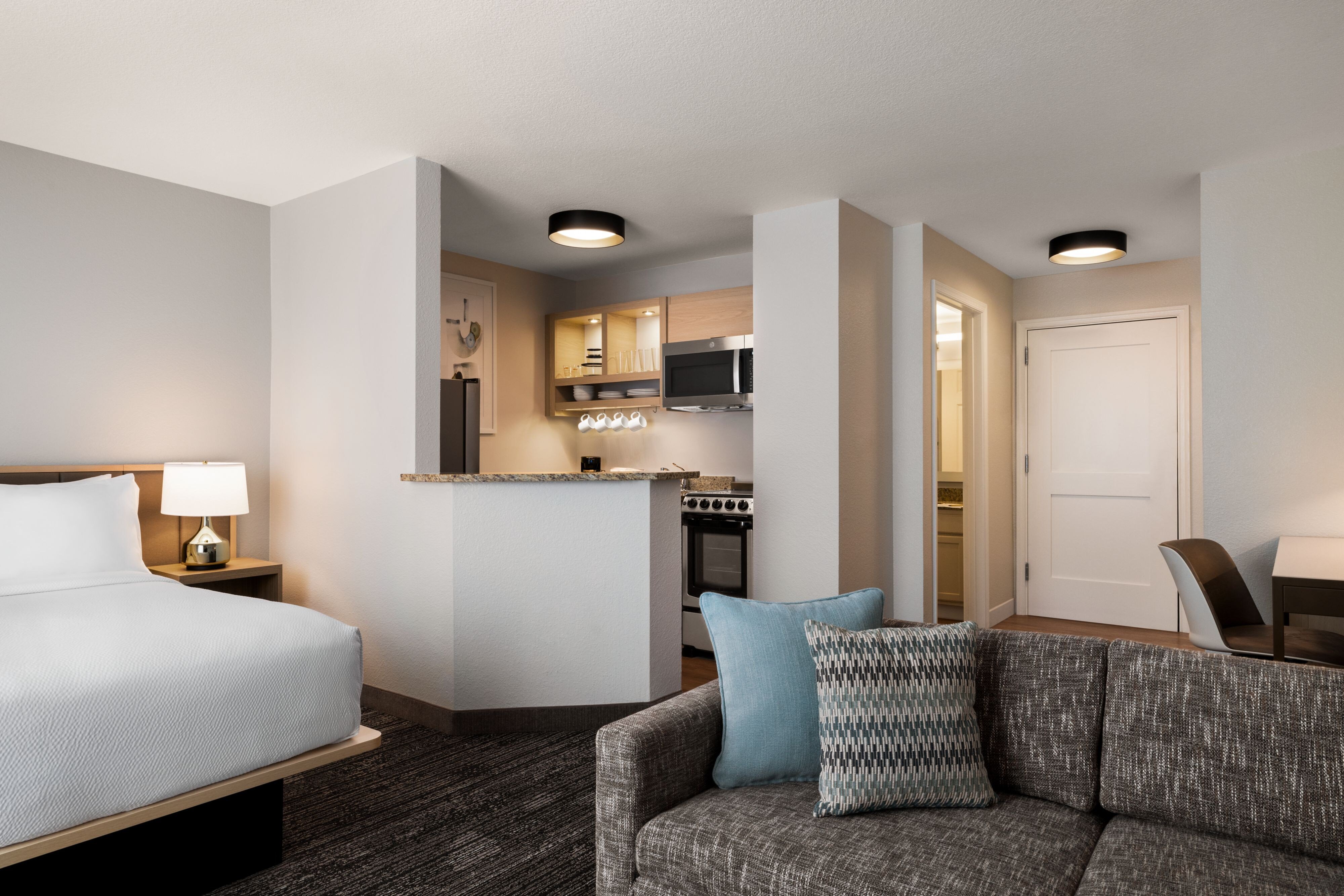 TownePlace Suites by Marriott Fort Meade National Business Park-guestroom-Studio suite, queen bed, seating area and kitchen.jpg