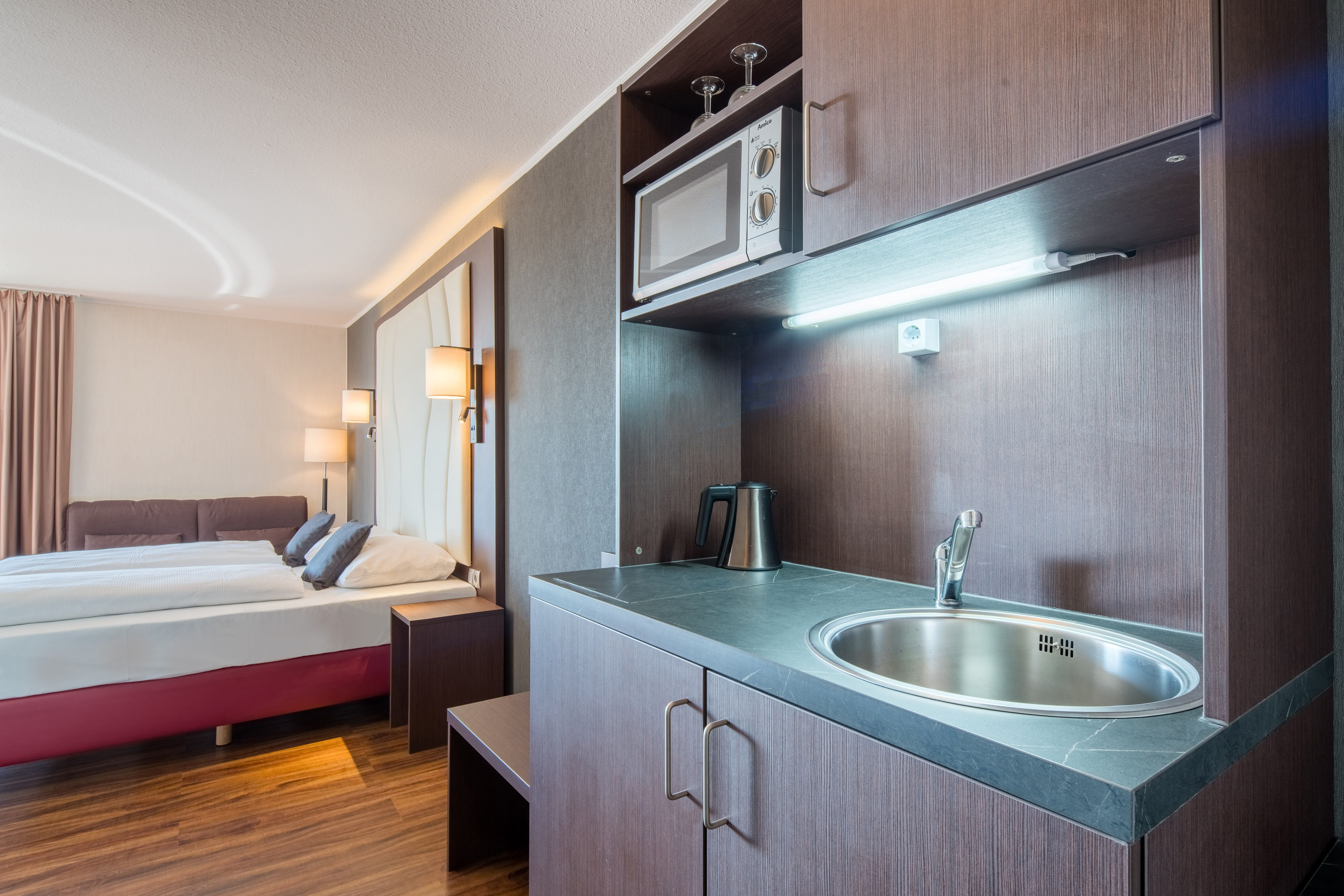 AIRWAYS HOTELS FRANKFURT AIRPORT WE-guestroom-Suite with kitchenette balcony.jpg