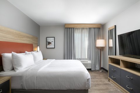 Relax in a private bedroom with a king-sized bed and ample space.