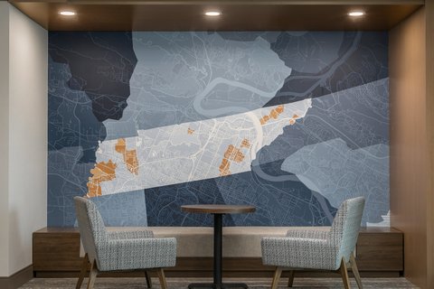 Relax in a cozy lobby space with Chattanooga artwork.