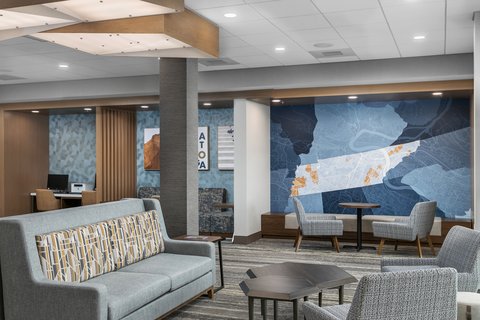 Relax in a cozy lobby space featuring Chattanooga artwork.