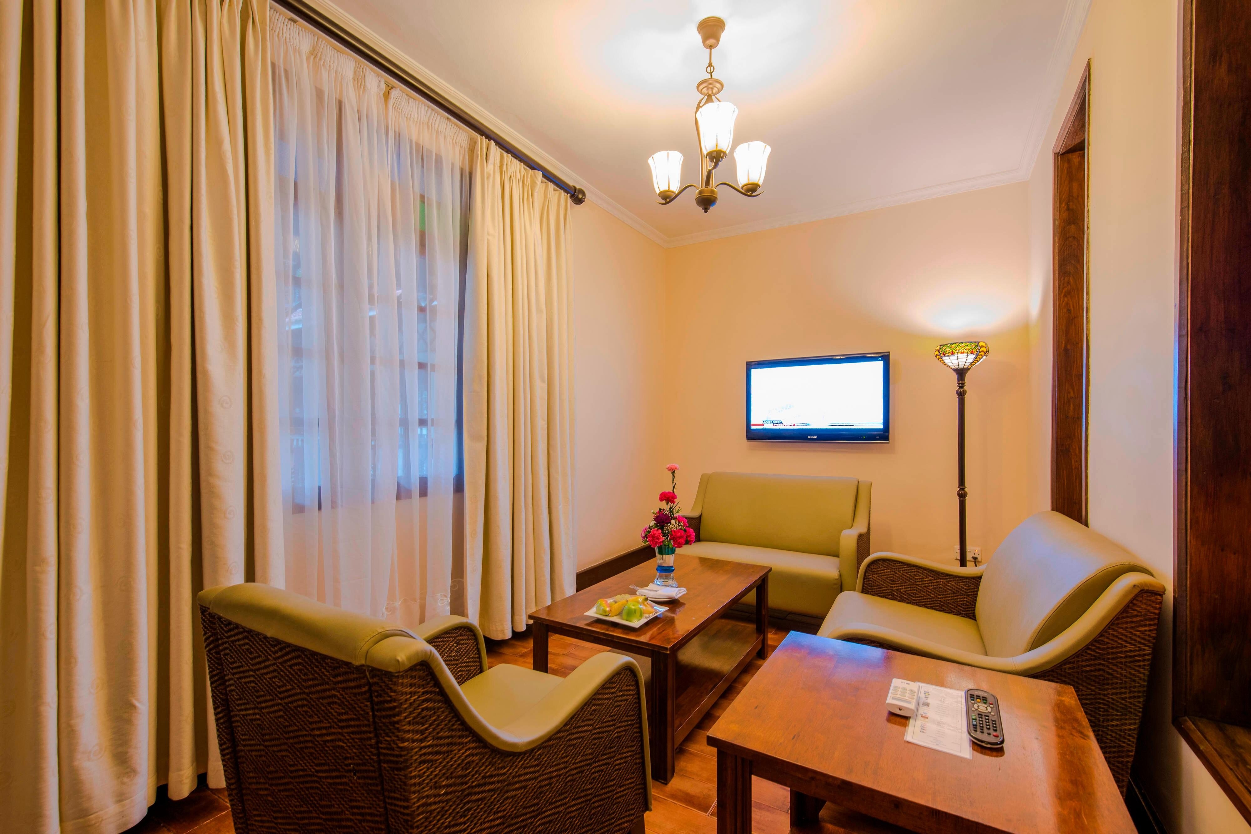 Protea Hotel by Marriott Dar es Salaam Courtyard-guestroom-Deluxe Seating Area.jpg