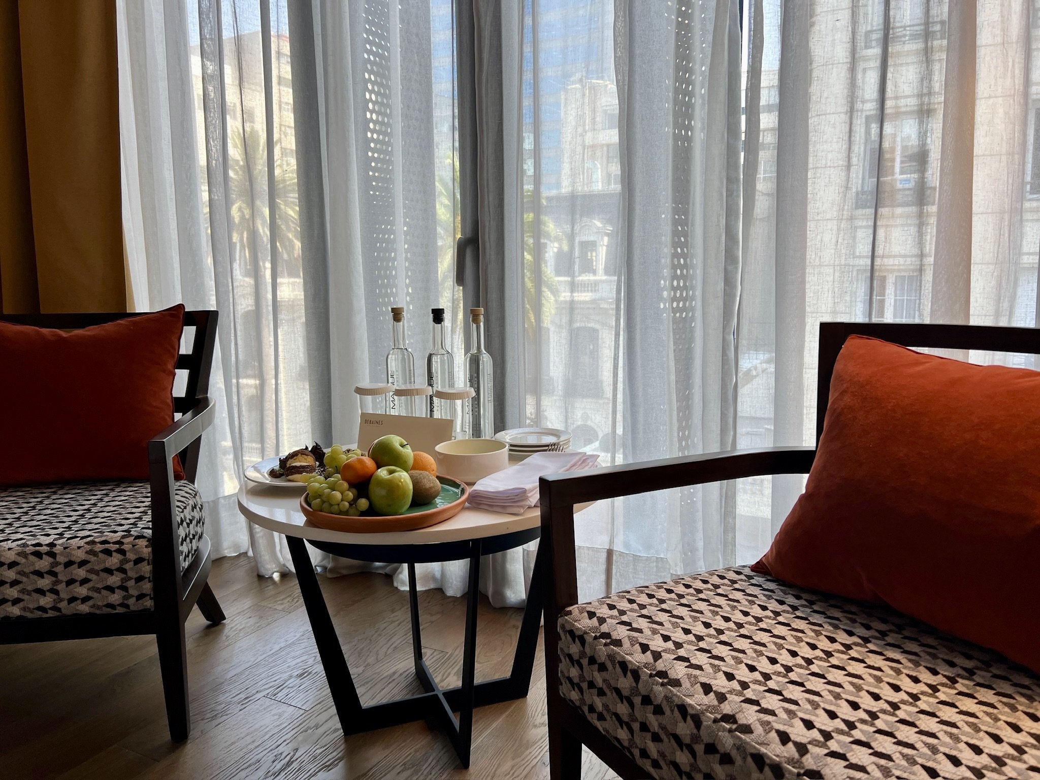 DEBAINES HOTEL SANTIAGO-guestroom-Deluxe Room Seating Area.jpg