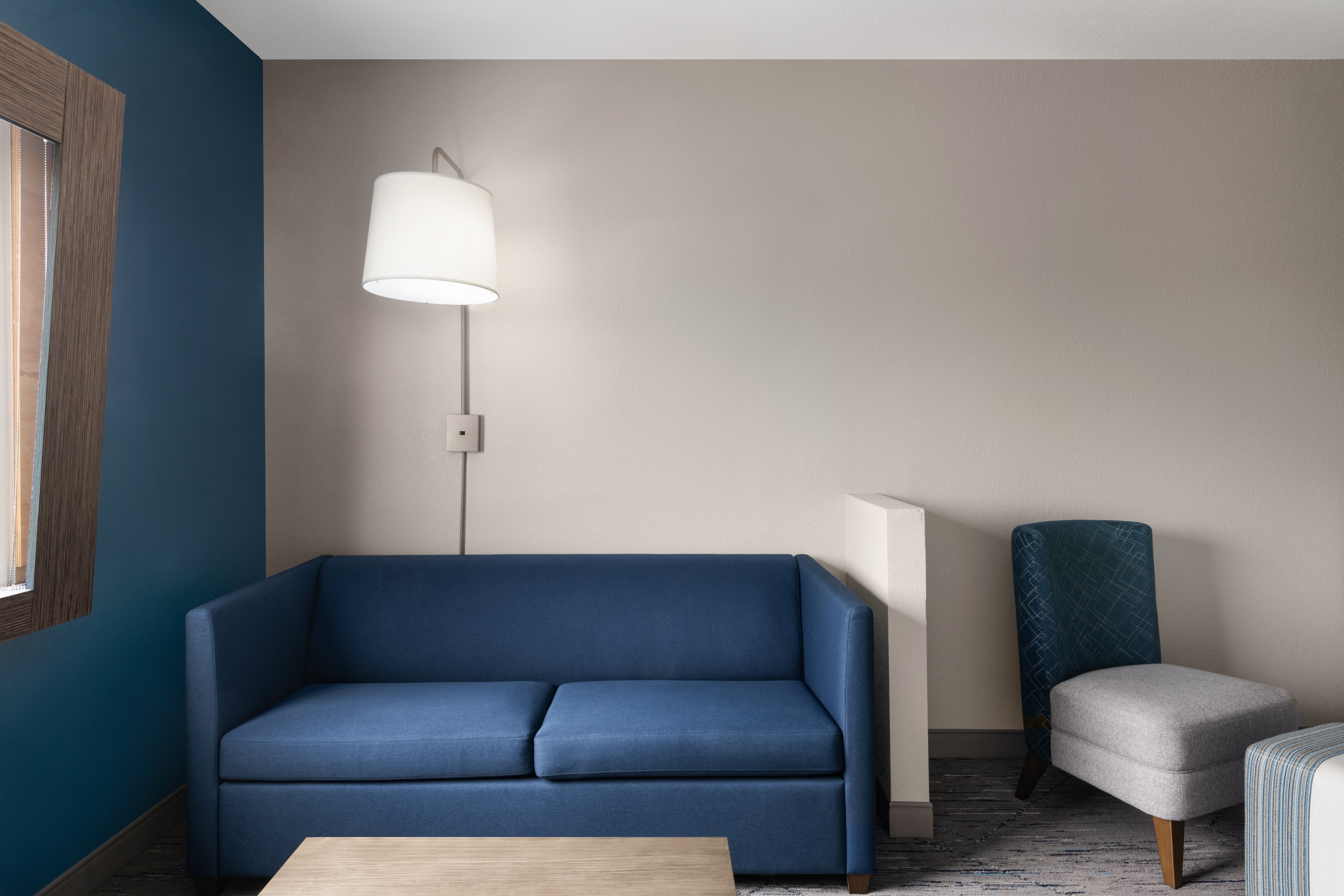 HOLIDAY INN EXP STES BOYNTON W BY I-guestroom-A cozy sleeper sofa makes room for everyone to relax..jpg