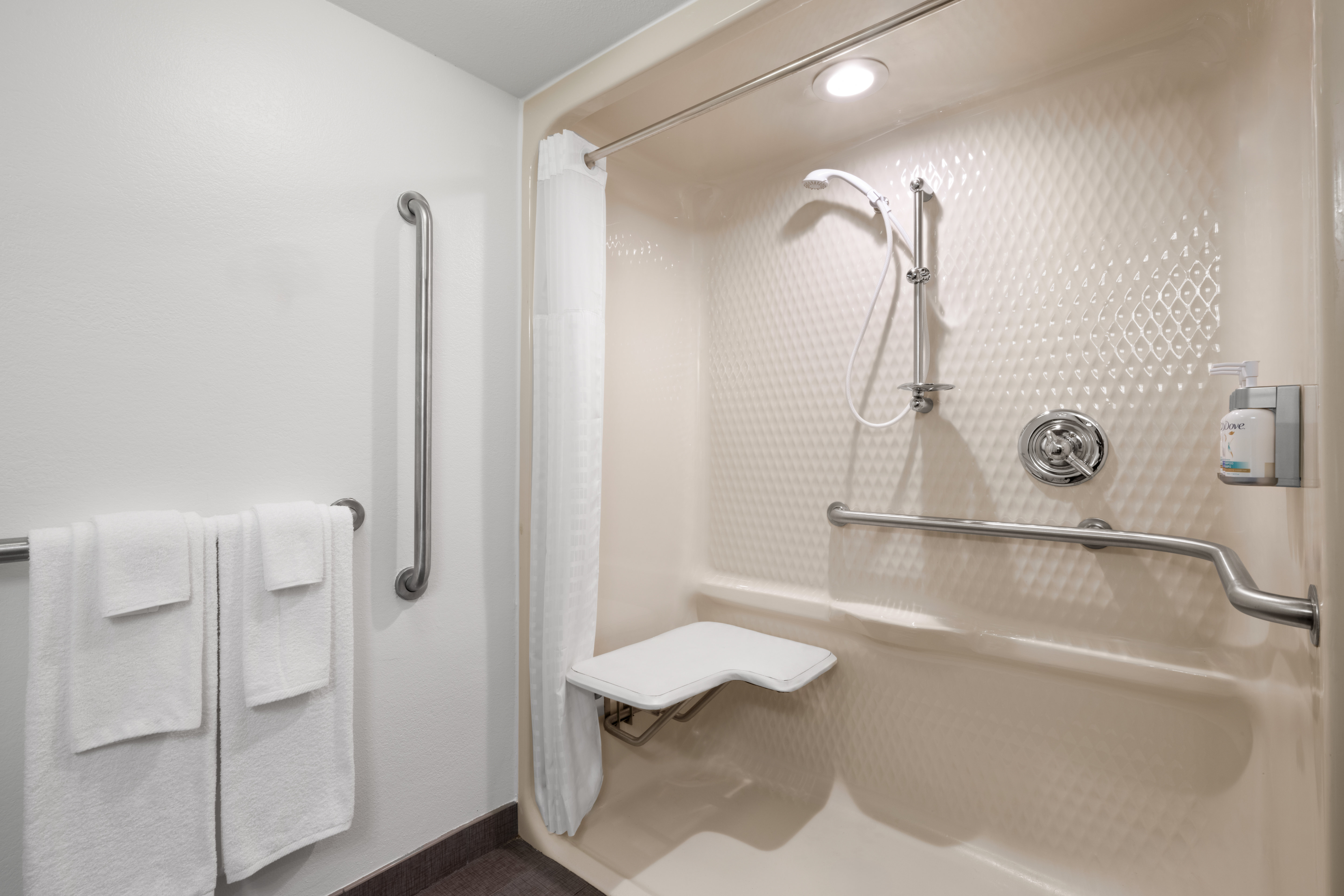 GARNER HOTEL WEST BY IHG-guestroom-Recharge in our spacious guest bathroom with an ADA roll-in shower.jpg