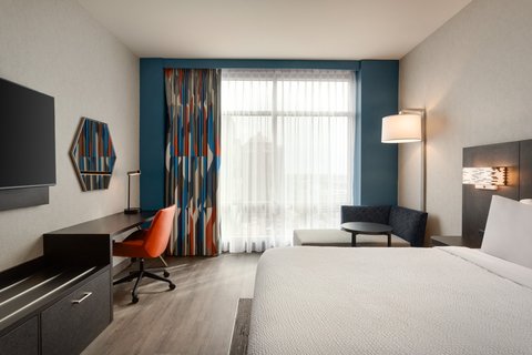 Standard King room with desk and seating in downtown Houston.