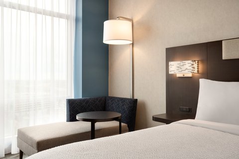 Standard King room with seating at our downtown Houston hotel.