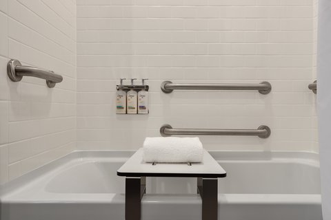 Accessible guest bathtub with grab bars in downtown Houston.