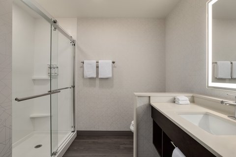 Standard bathroom with glass shower at our downtown Houston hotel.