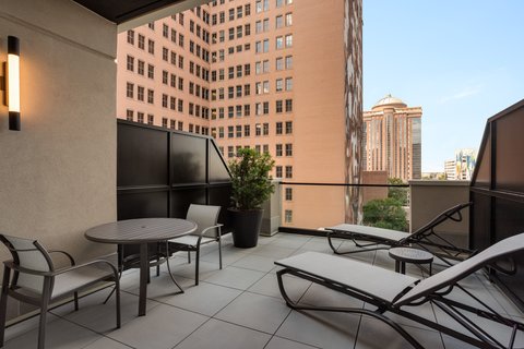 King room balcony with seating and downtown Houston views.