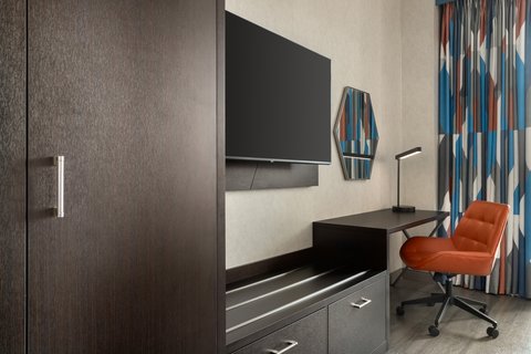 King Standard room with desk and TV in downtown Houston.