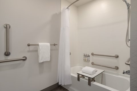 Accessible bathtub with grab bars in downtown Houston hotel.