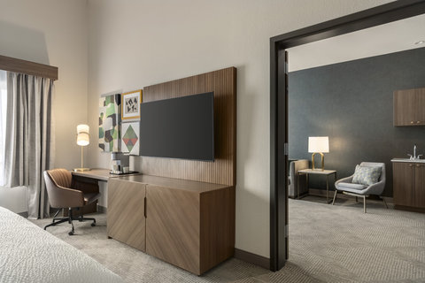 One bedroom suite with a separate living area and workspace.