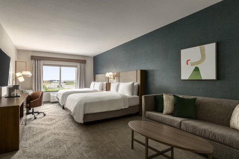Two queen suite with a sofa seating area and a work desk.