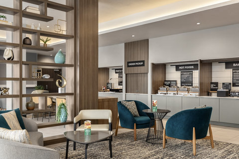 Breakfast seating area with cozy lounge chairs and a buffet.