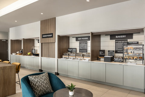 Spacious breakfast area with a buffet and comfortable seating.