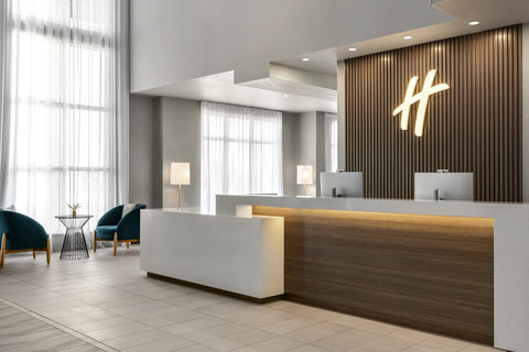 Welcoming lobby and front desk at Holiday Inn Commerce City.