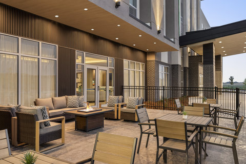 Relaxing outdoor patio with a fire pit and lounge seating.