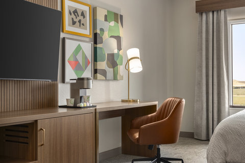 Guest room workspace with a desk and in room coffee station.