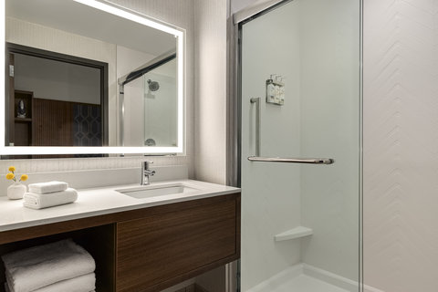 Guest bathroom with a spacious walk in glass shower and vanity.