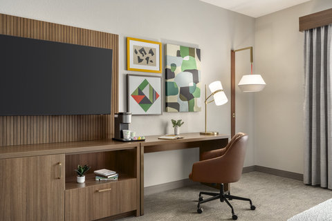 King room desk with an in-room coffee station and a flat TV.