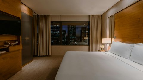 Suite Bedroom with city skyline evening views