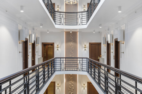 Move through bright corridors shaped by historic details