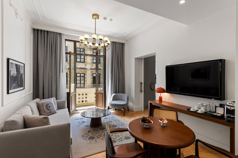 Your spacious suite comes with a TV, sofas, tables and a balcony