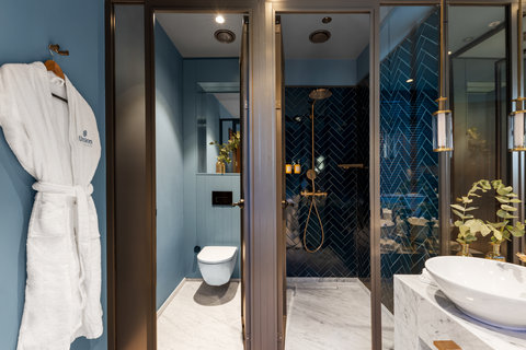 Slip into your robe and unwind with your premium blue bathroom