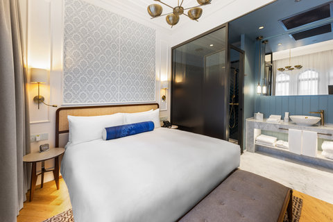 Sink into crisp bedding with your glass-walled ensuite bathroom