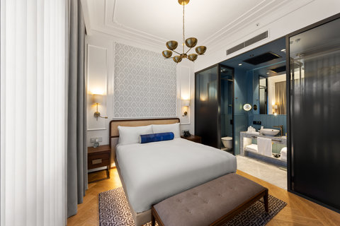 Your bedroom flows into a blue-tiled ensuite with marble finishes