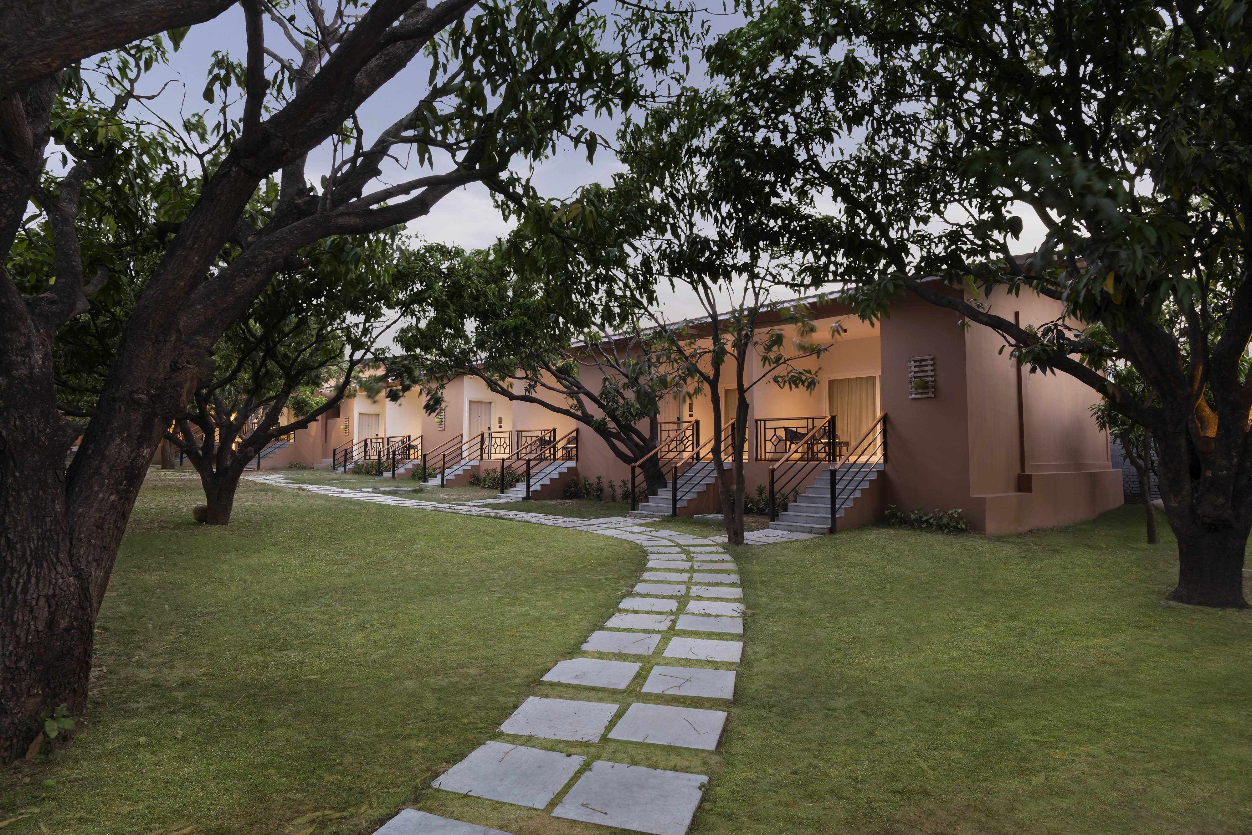 VOCO JIM CORBETT BY IHG-guestroom-Rooms are nestled amidst green cover of mango trees.jpg