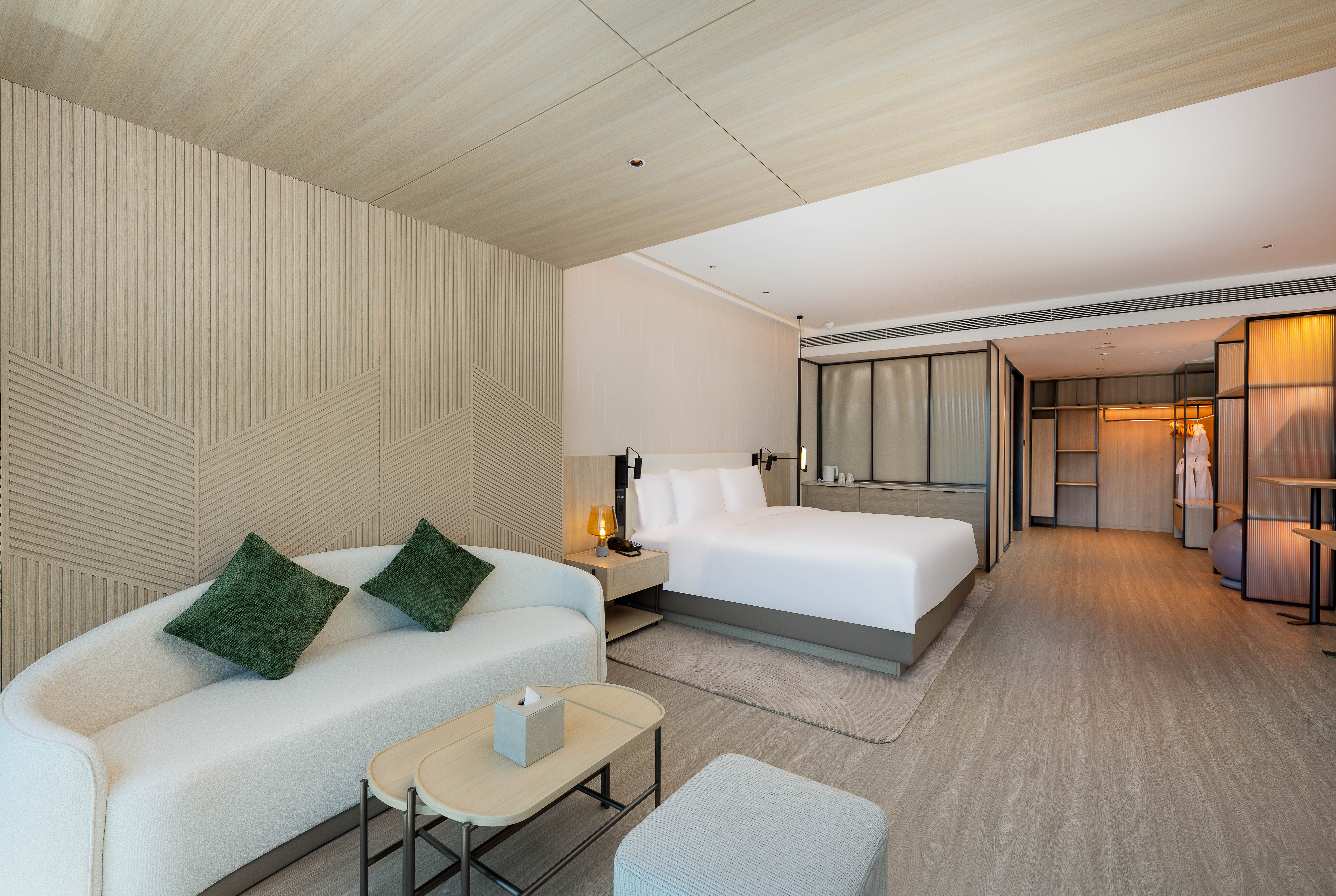 EVEN QINGDAO LAOSHAN BY IHG-guestroom-1 King Premium Smart Room Living area.jpg