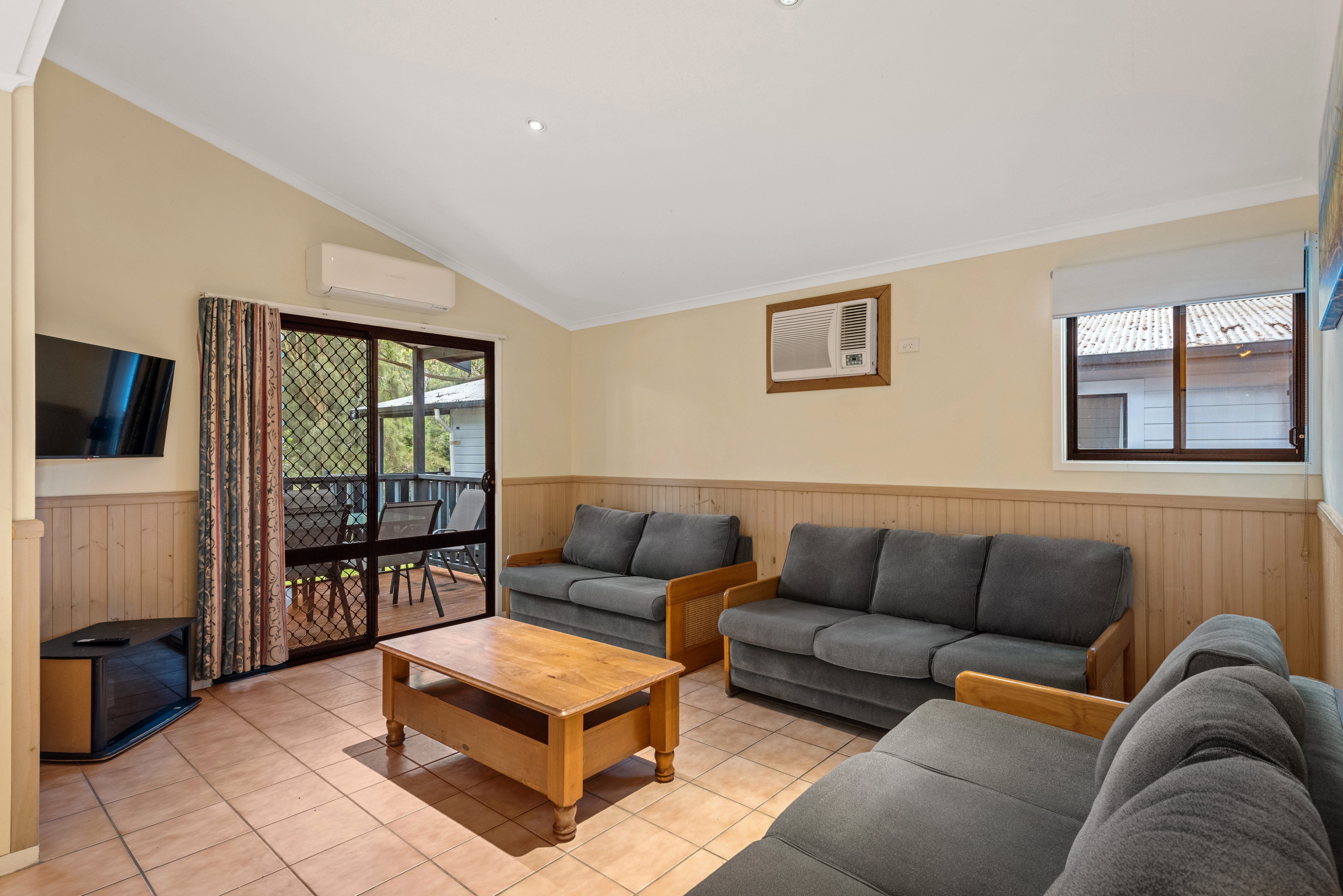 DISCOVERY PARKS - NAROOMA BEAC-guestroom-Dlx 3BR Cabin Slps 8 (2362) - Living Area.jpg