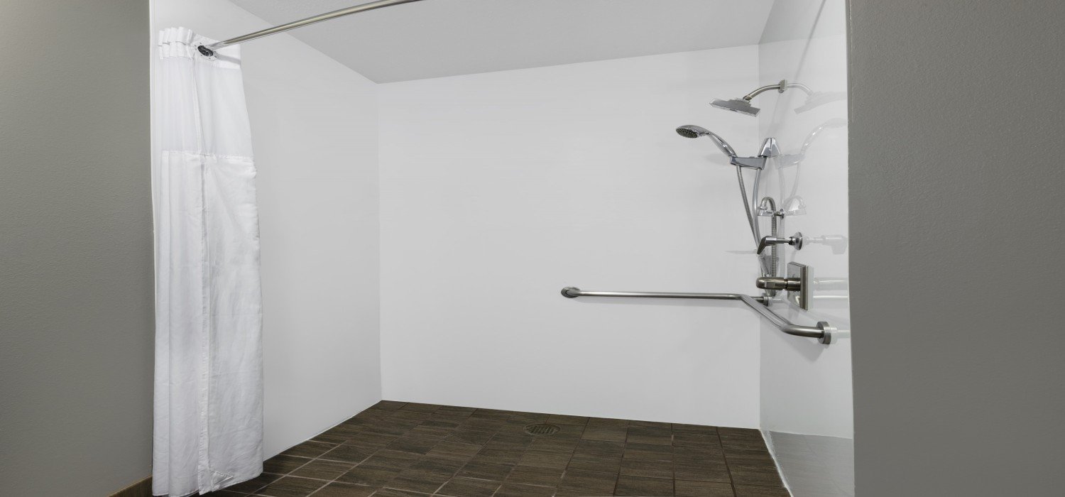 HOTEL 1550-guestroom-Accessible Kng Room Bath Roll In Shower.jpg