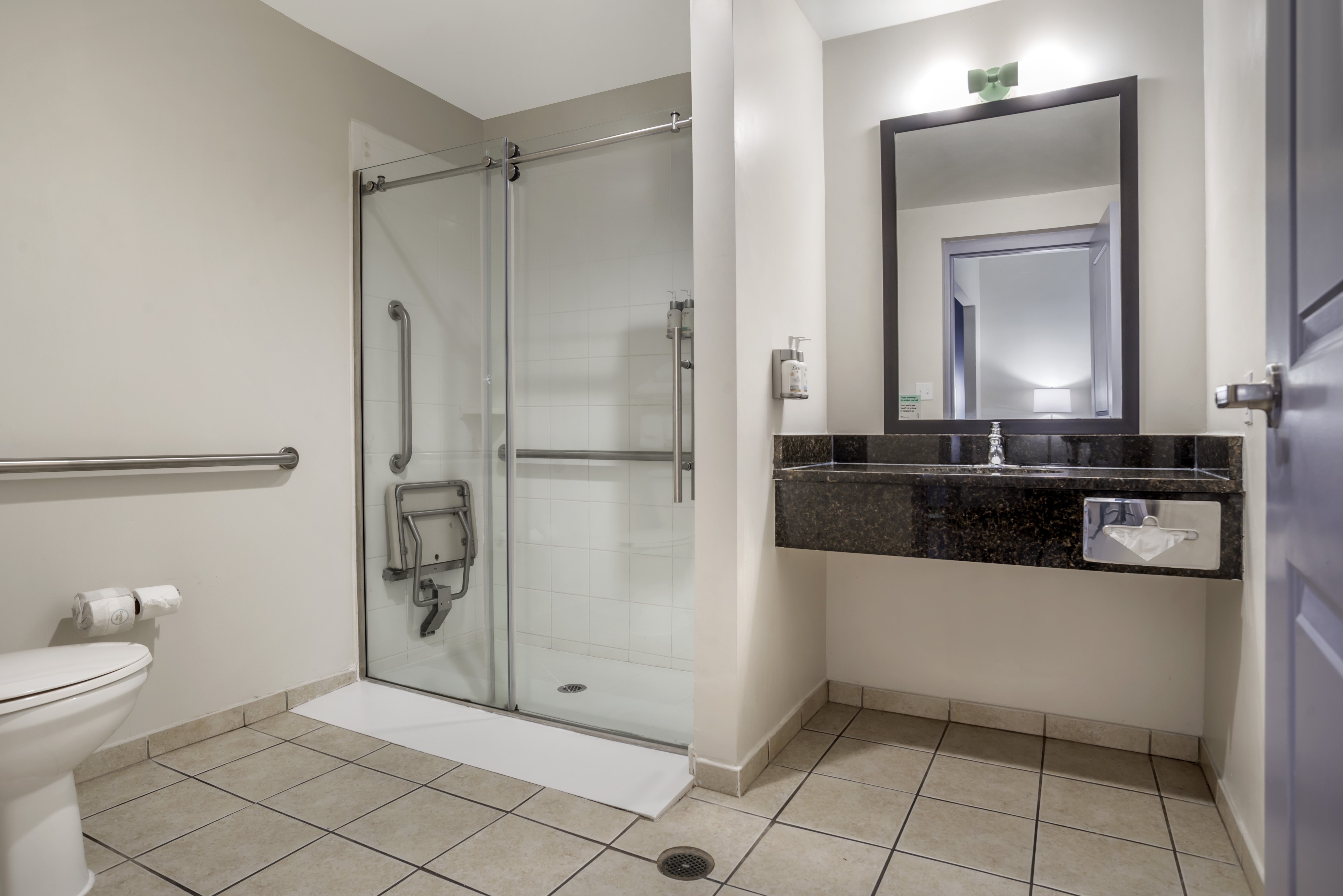 GARNER HOTEL PANAMA CITY BEACH NE B-guestroom-Recharge in our spacious guest bathroom with an ADA roll-in shower.jpg