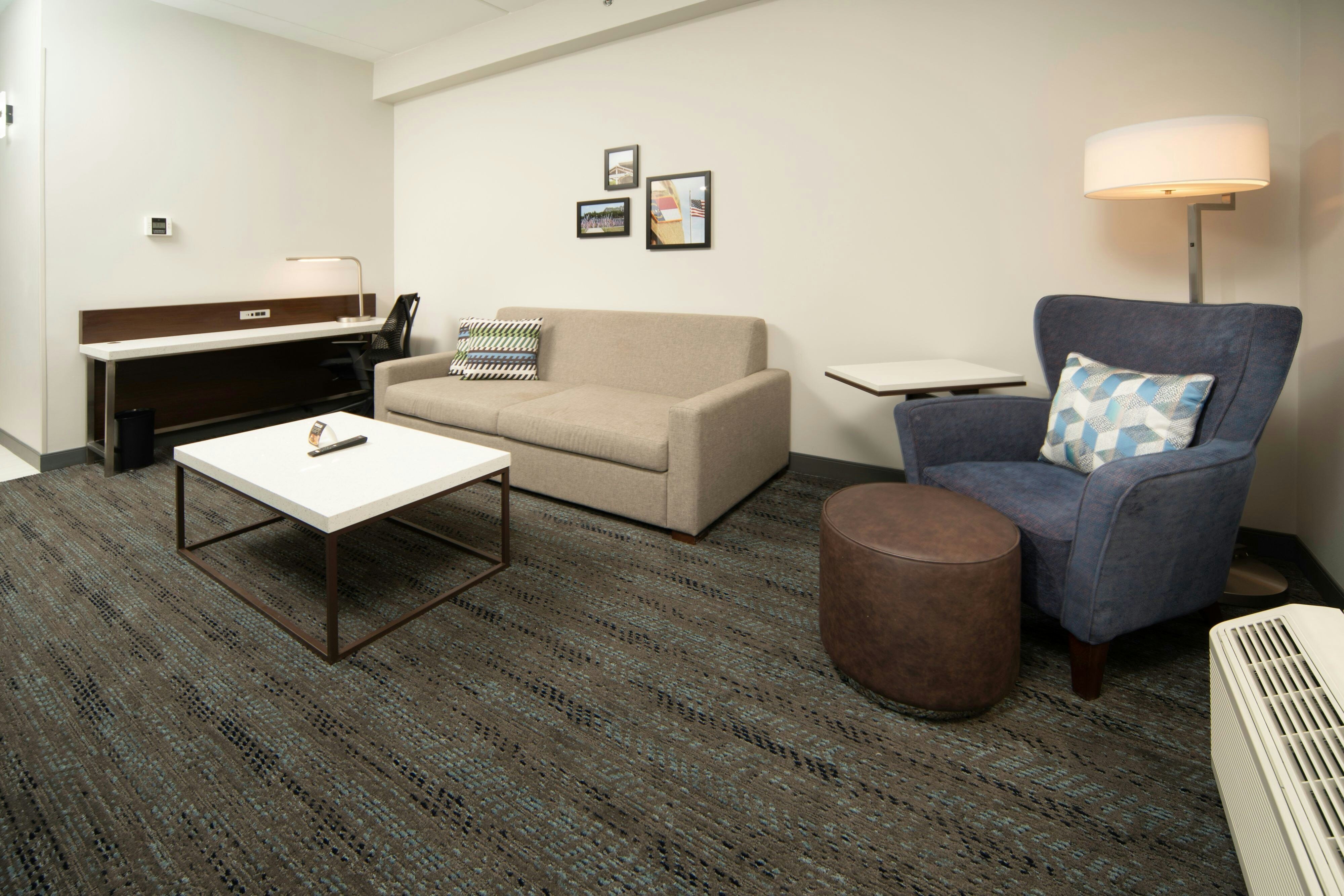 Four Points by Sheraton Fayetteville Fort Bragg-guestroom-Suite with sofa and chair.jpg