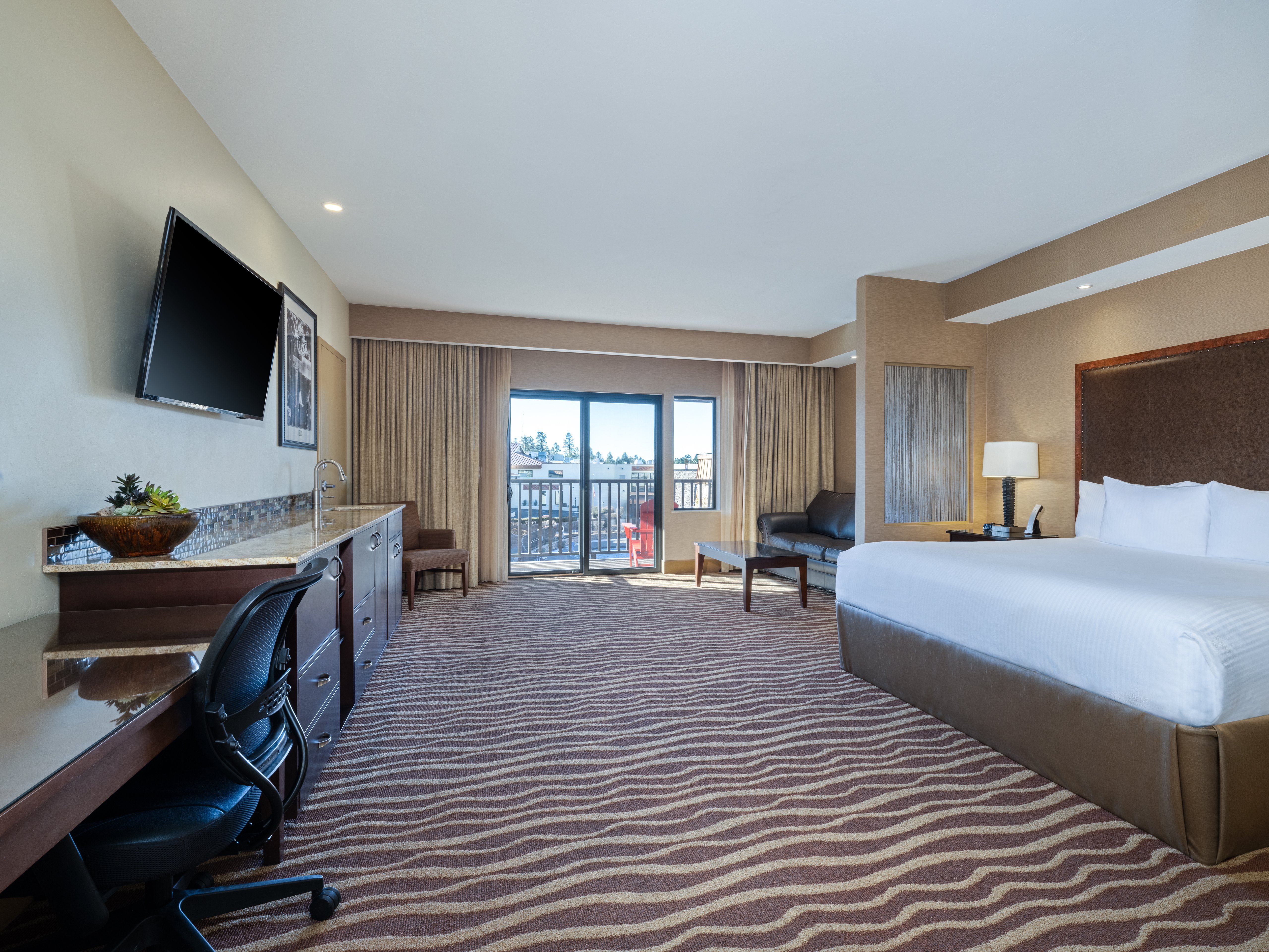 HOLIDAY INN RESORT SQUIRE GRAND CAN-guestroom-Enjoy amazing views in a king suite with a balcony..jpg