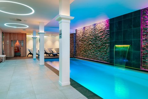 Relaxing indoor pool with modern stone walls