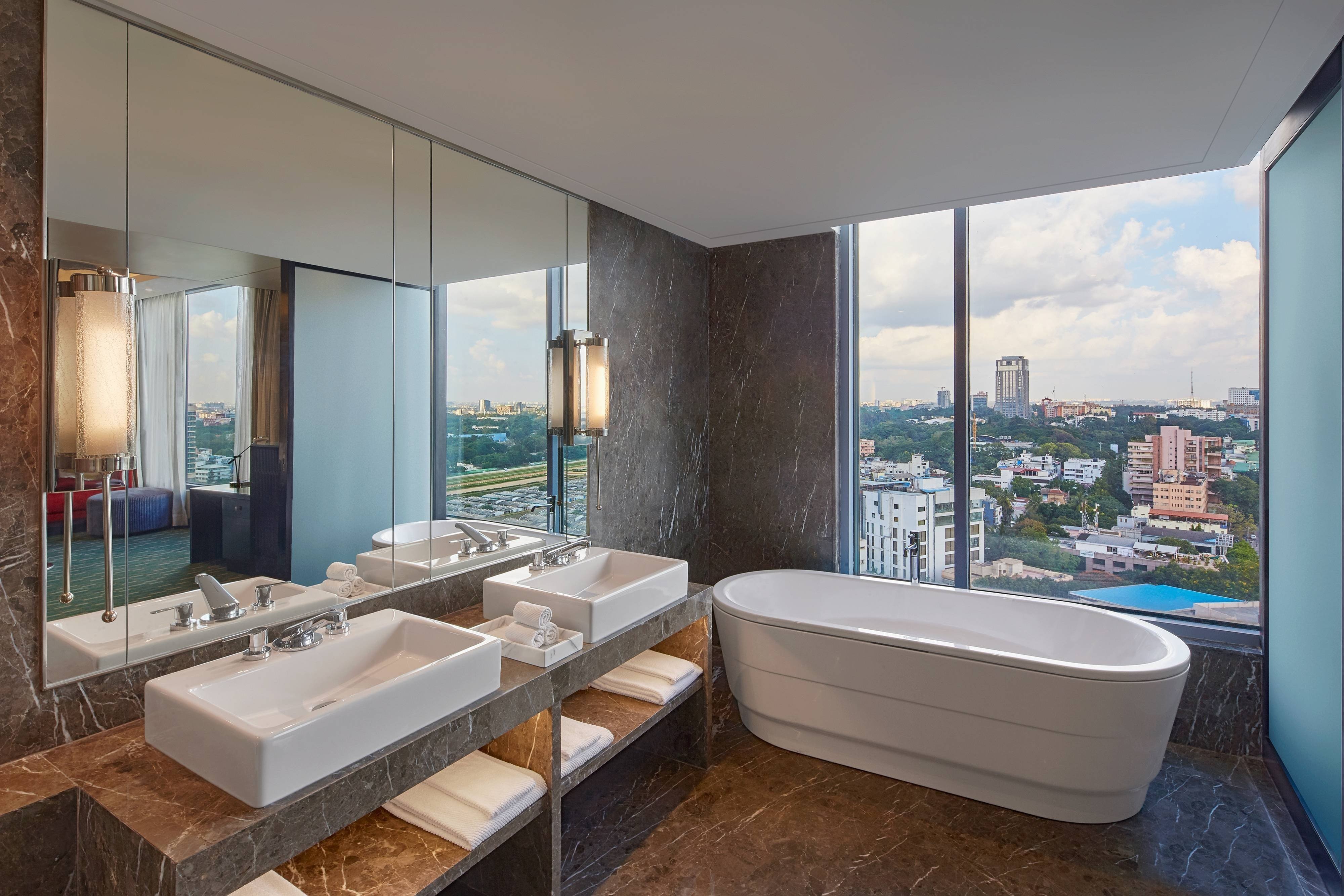 Renaissance Bengaluru Race Course Hotel-guestroom-Bathroom Soaking Tub with View Large Room.jpg