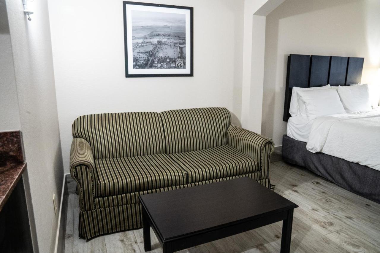 Lucille s Hotel-guestroom-One King Bed Suite Sofa.jpg