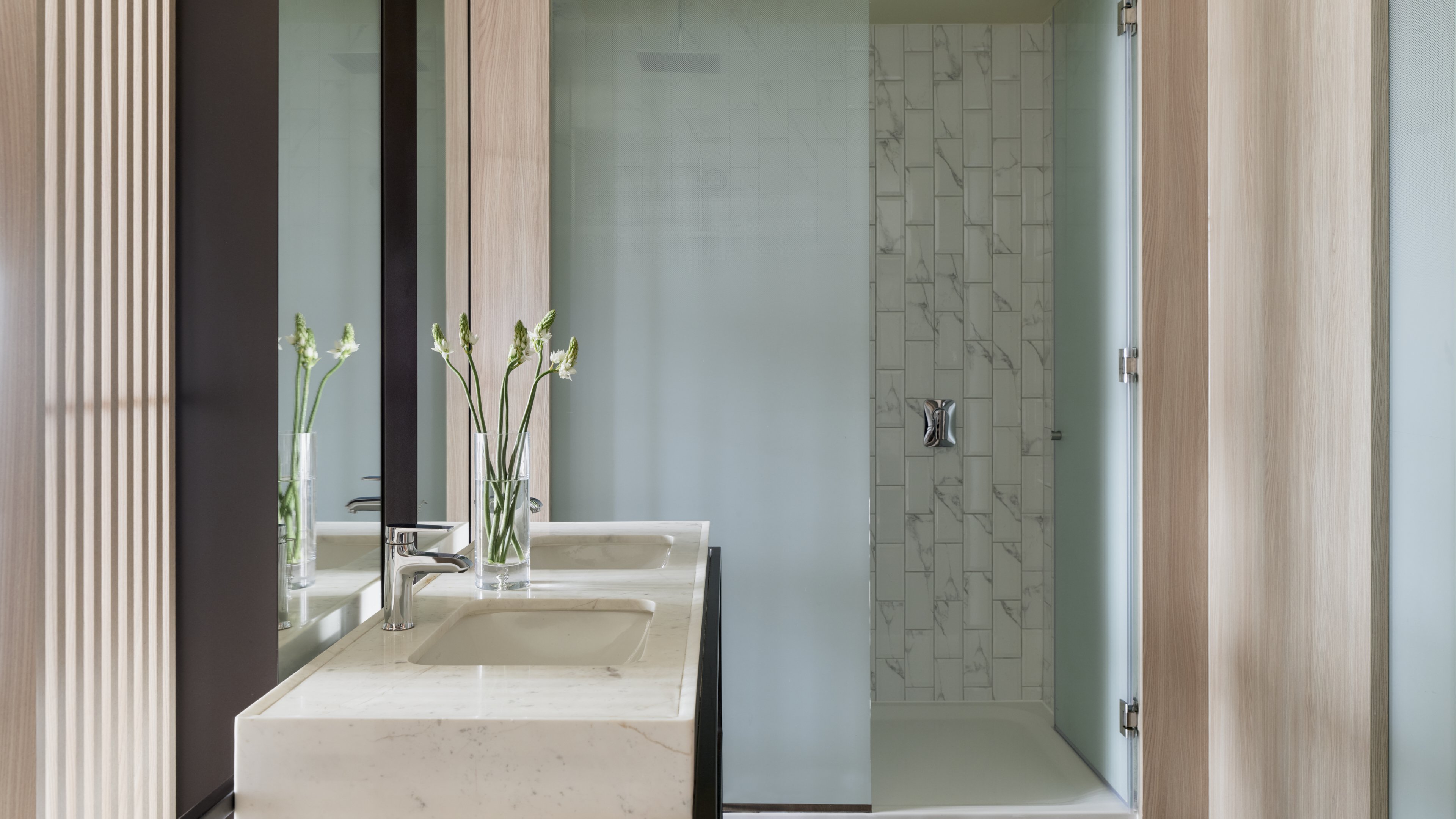 VIGNETTE COLLECTION SOUMA HOTEL BY-guestroom-Elegant bathroom with dual sinks and a spacious walk-in shower..jpg