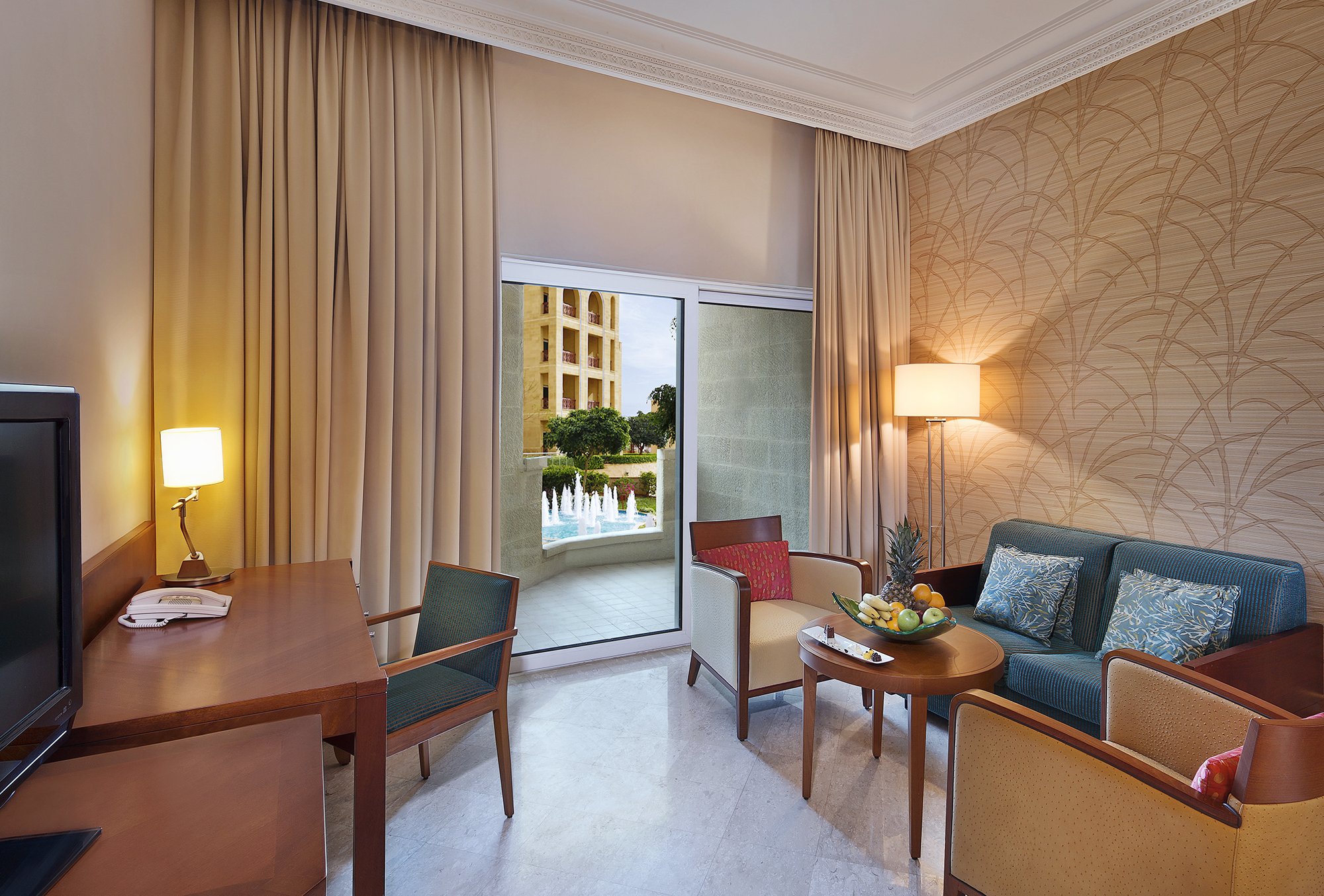 CROWNE PLAZA DEAD SEA JORDAN BY IHG-guestroom-living area to relax, with a balcony overlooking the fountains.jpg