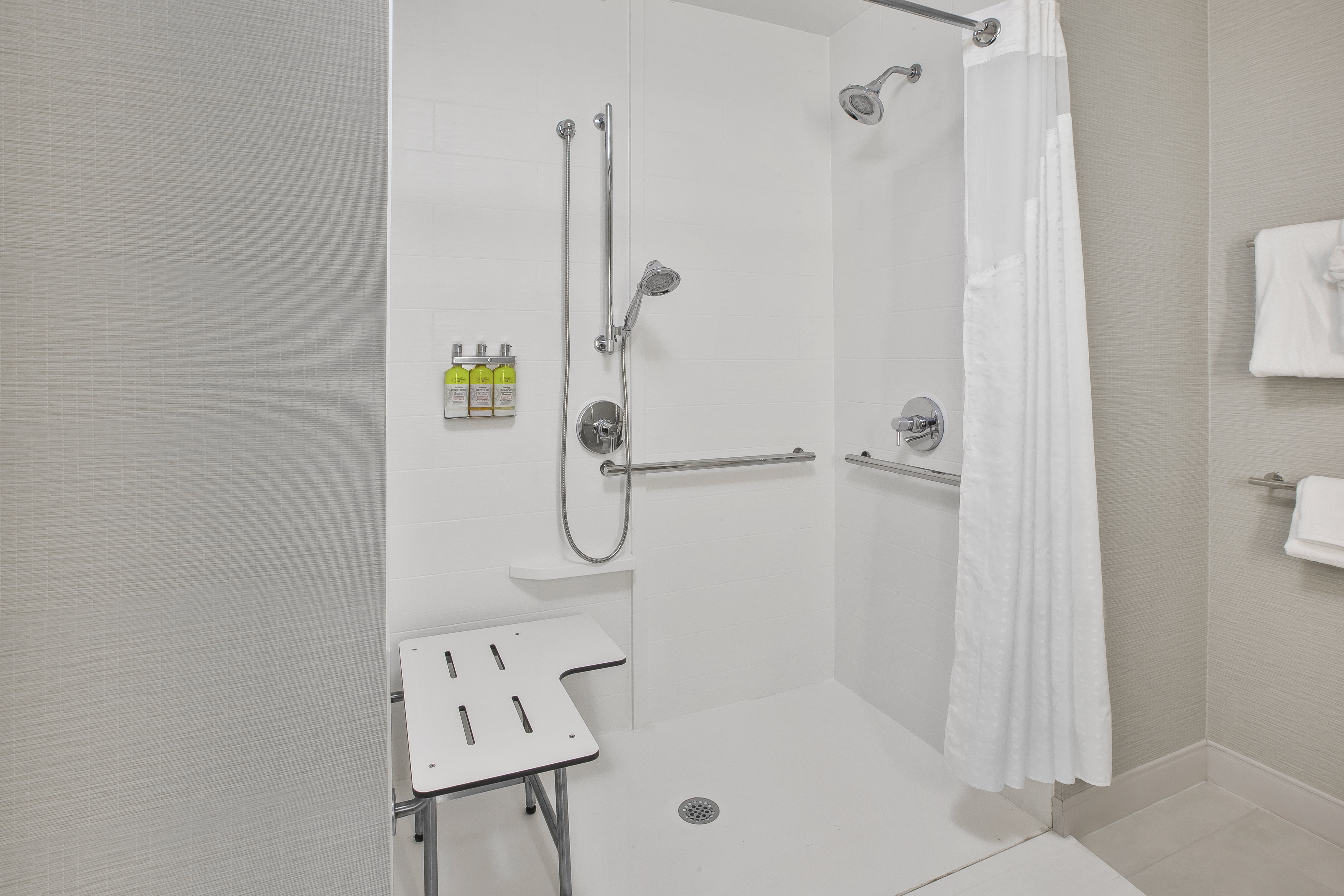 Accessible bathroom with a roll-in shower.