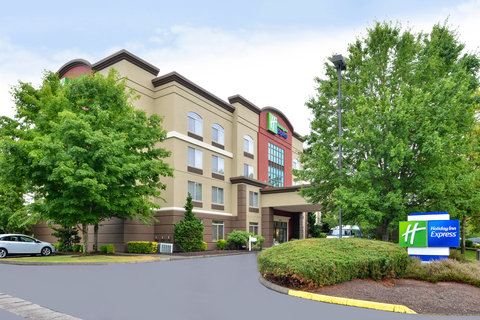 Welcoming Holiday Inn Express with lush greenery.